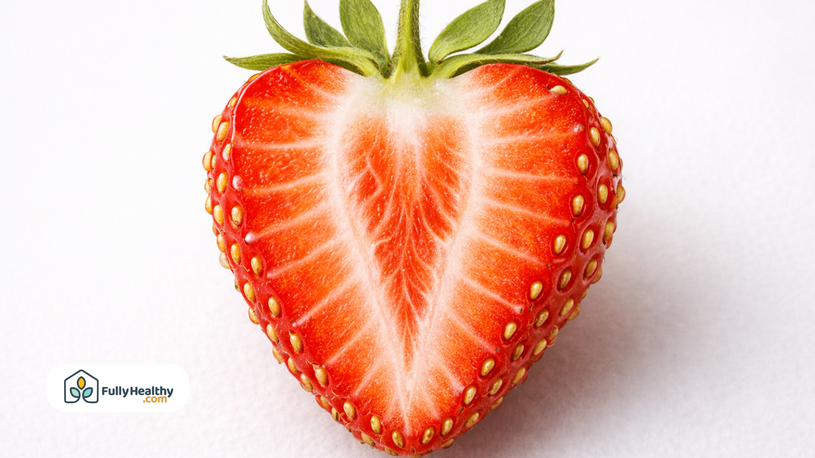 Fresh strawberry cut in half showing juicy flesh and visible seeds