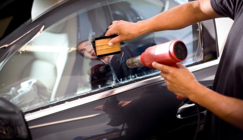 Adhesive side of window film on car adjustment