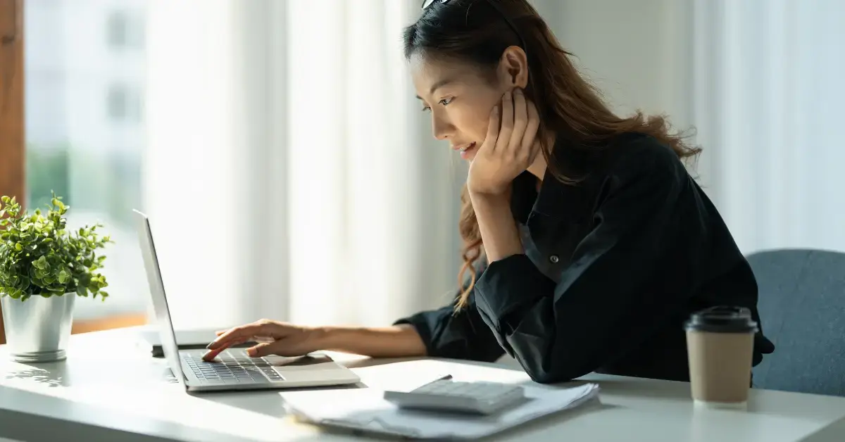 Woman reviewing a streamlined installment agreement and IRS tax payment plan at her desk.