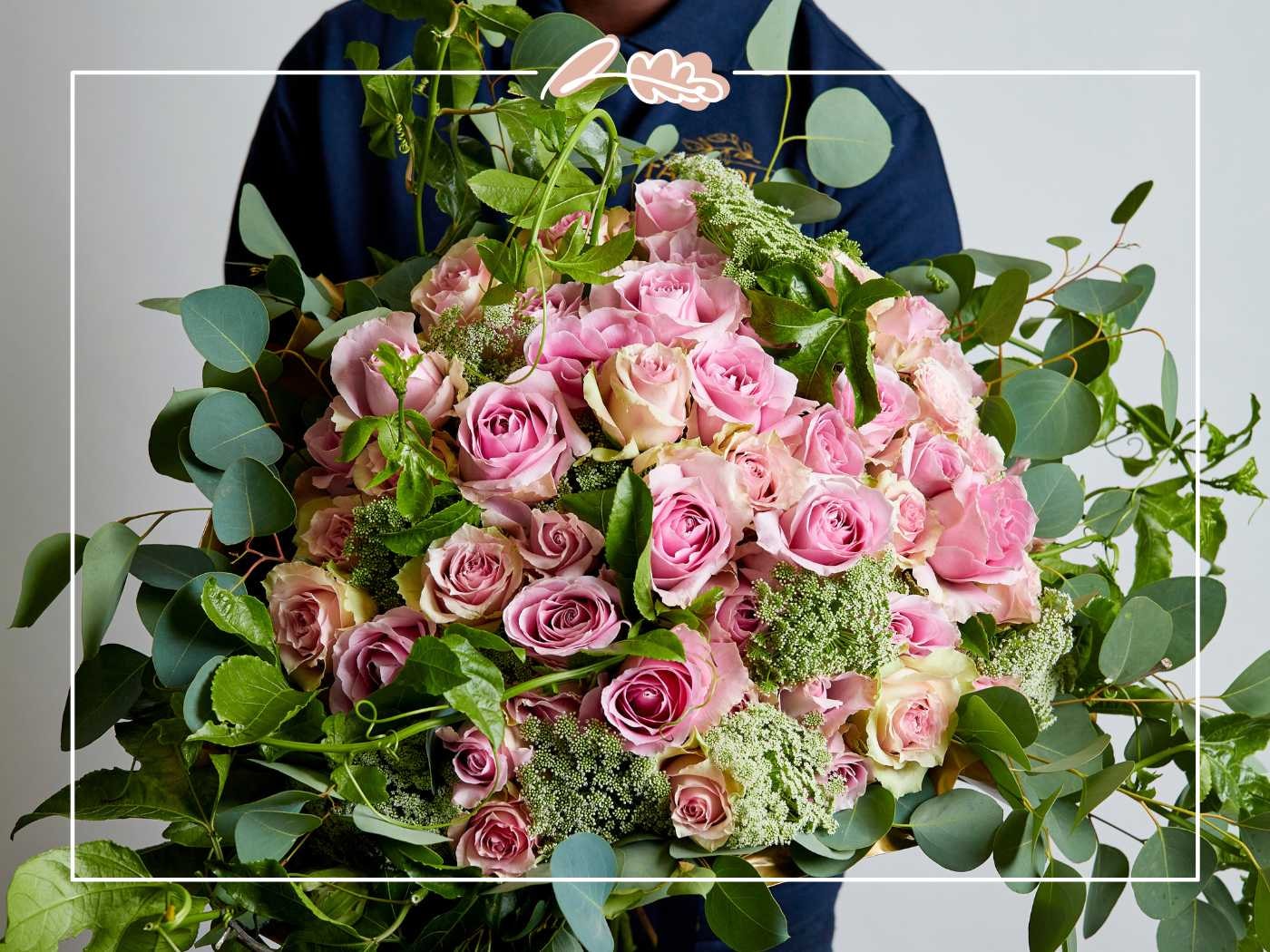 A lush arrangement of pink roses and green foliage, beautifully crafted for a special occasion - Fabulous Flowers and Gifts.