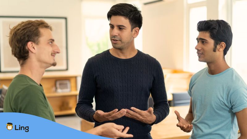 A photo of a language learner talking to native speakers that teach Malayalam.