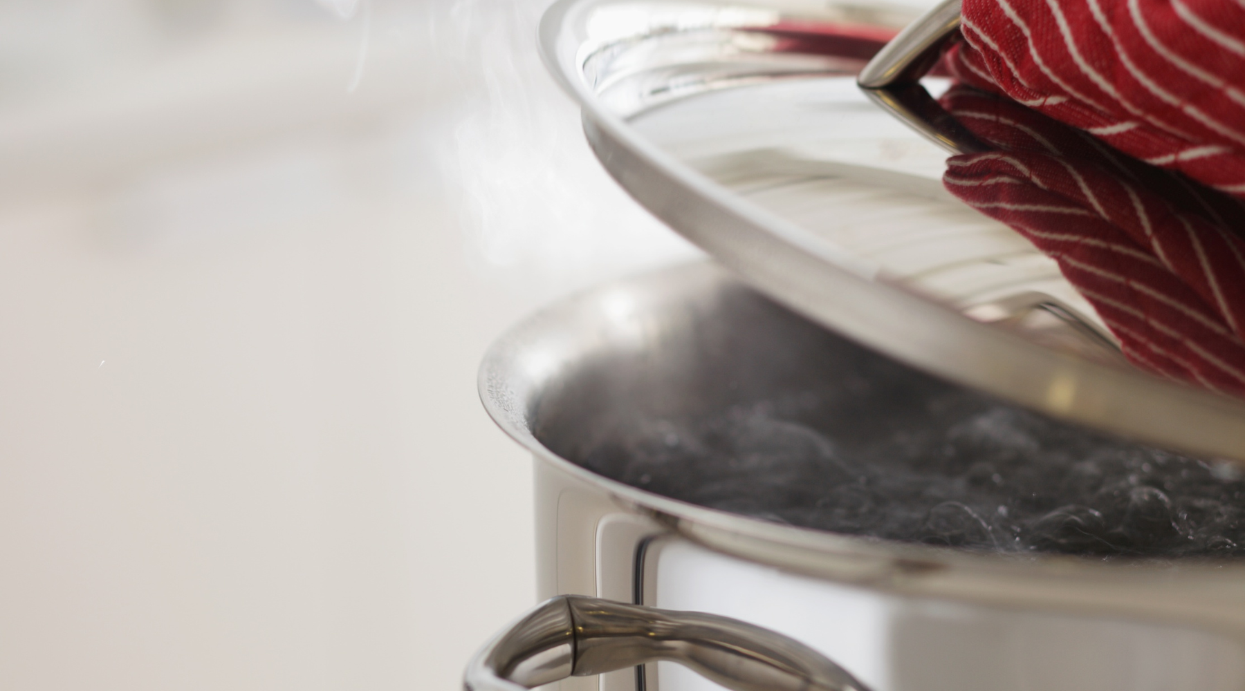 boiling water for boneless skinless chicken breast on a cutting board