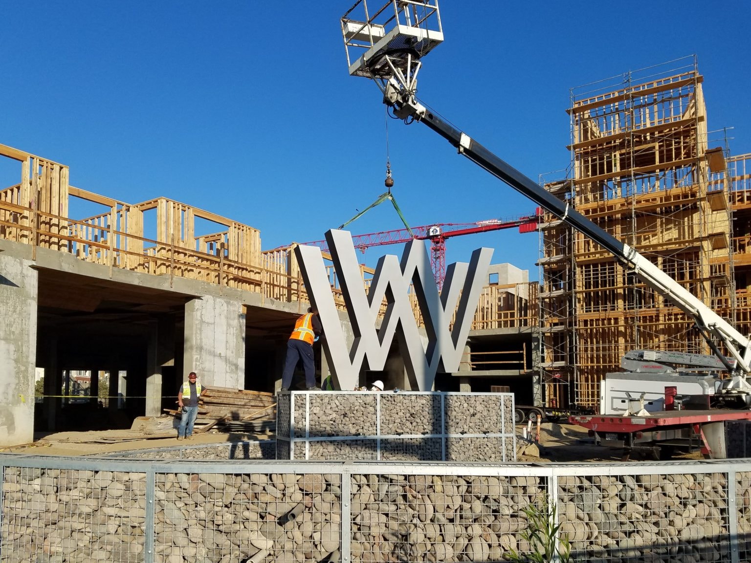 Our team installing one of the custom WW logo signs at Wagon Wheel in Oxnard, part of a comprehensive sign program developed for Oakwood Communities’ master-planned vision.
