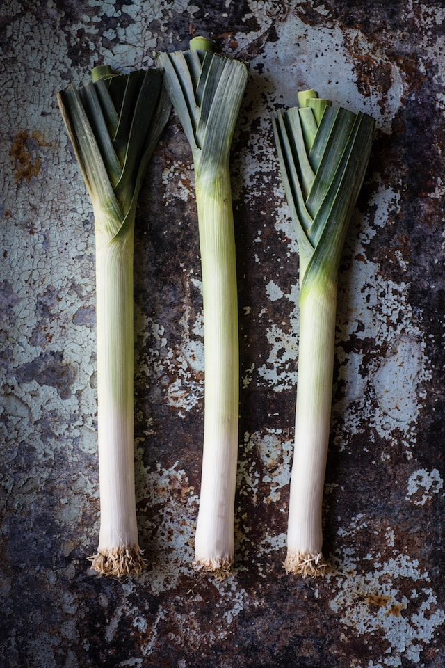 three leeks lying side by side