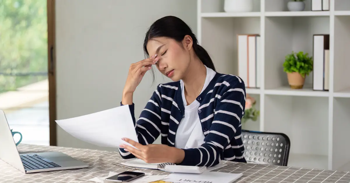 Woman reviewing finances and planning taxes based on 2026 income tax brackets.