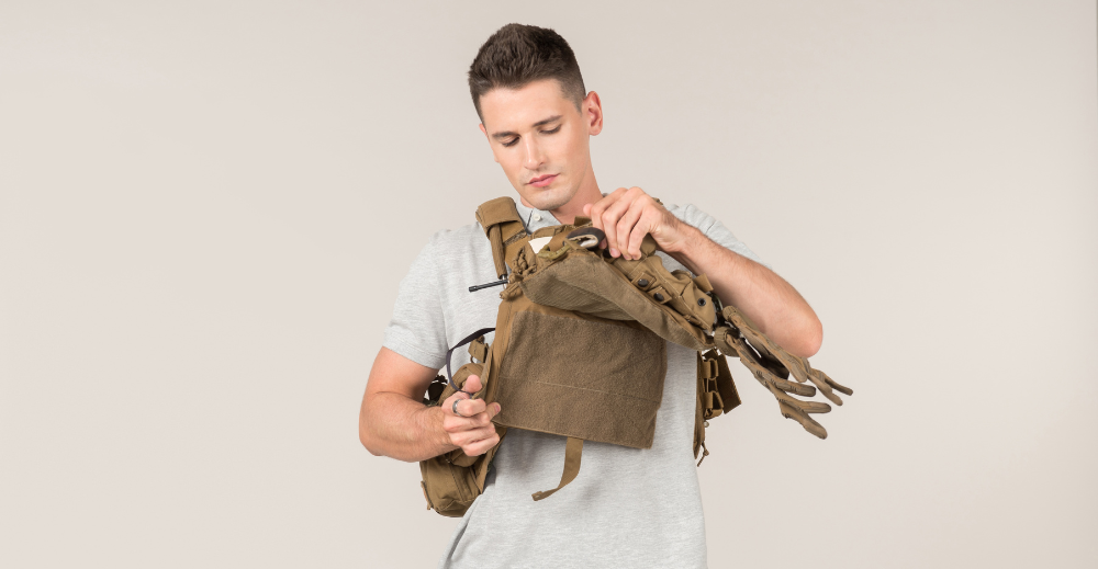 Guy checking his ballistic vest