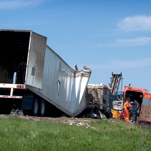An image showing commercial truck drivers near a commercial vehicle after an accident in Alabama.