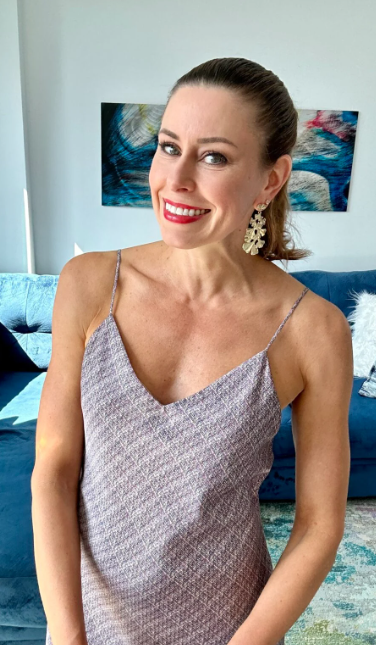 Mary Zubritsky showcasing an elegant v-neck dress delivered by Rent the Runway as a part of their monthly clothing rental service.