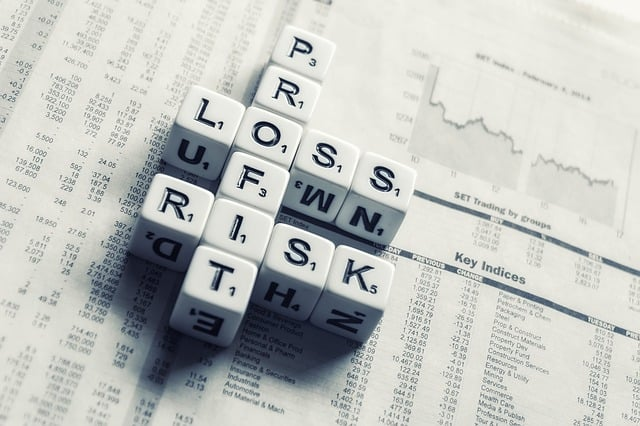 dices over newspaper, profit, loss risk, sell stocks