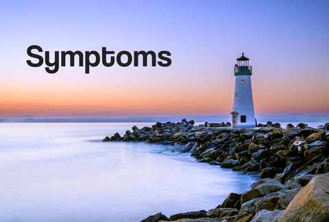 A lighthouse on the edge of a beach at sunset. The words – Symptoms – can be seen