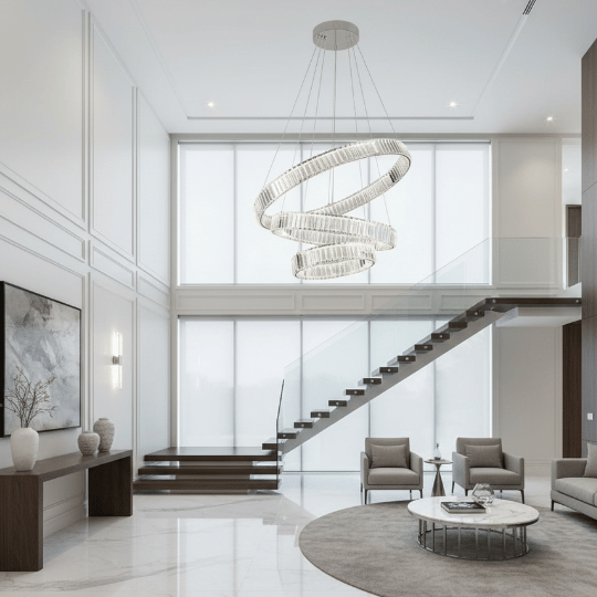 Modern spiral crystal chandelier with cascading LED rings creating a striking centerpiece in a bright double-height foyer.