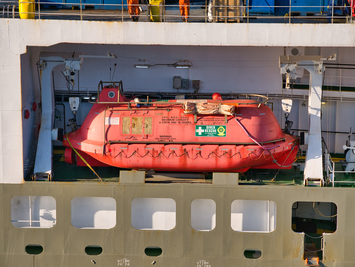 A hyperbaric lifeboat on a North Sea support vessel in Aberdeen harbour.