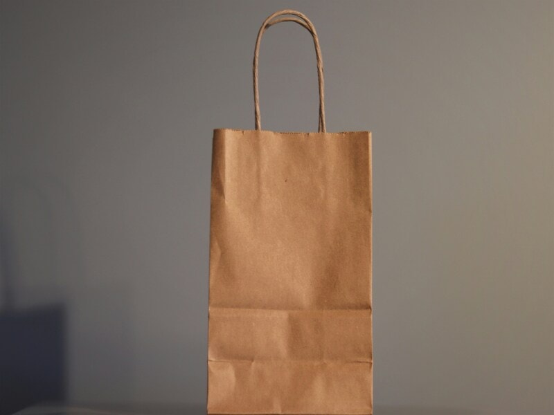 Brown paper lunch bag for carrying food items. Sturdy handles helps you carry it easily over large distances. 