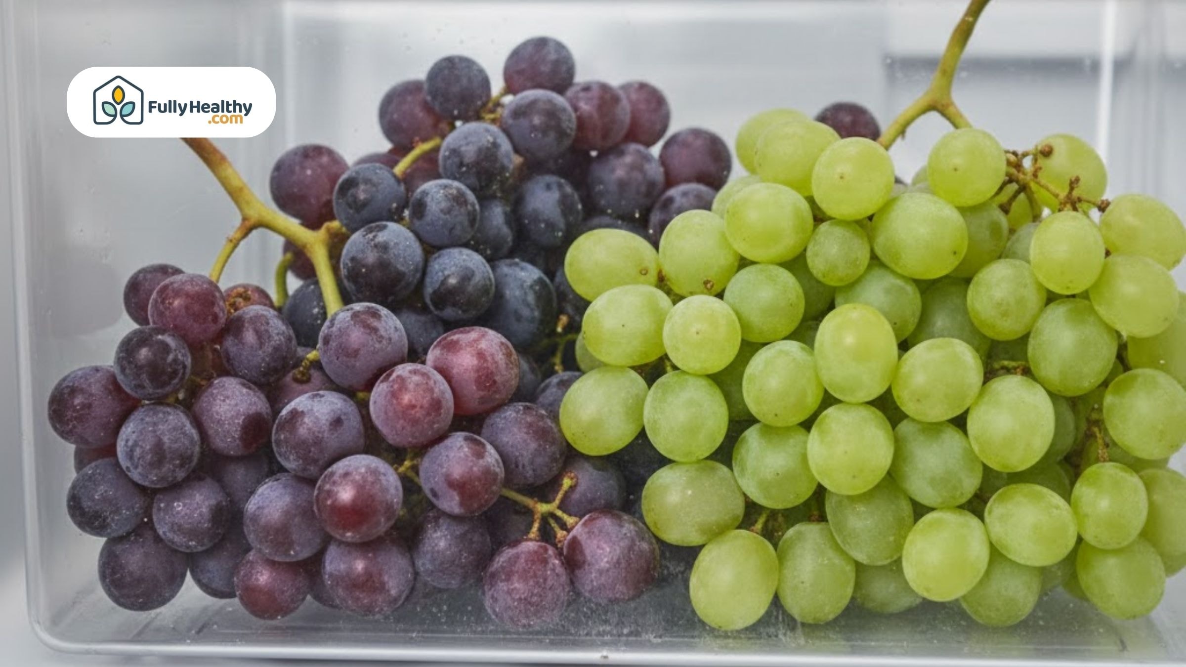 Green and red grapes arranged in a plastic container in the fridge.