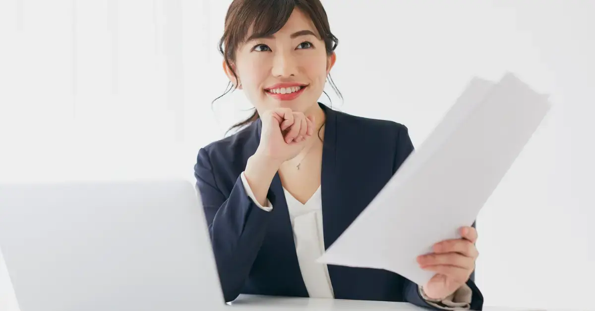 Female entrepreneur reviewing financial data after learning how to calculate adjusted gross income.