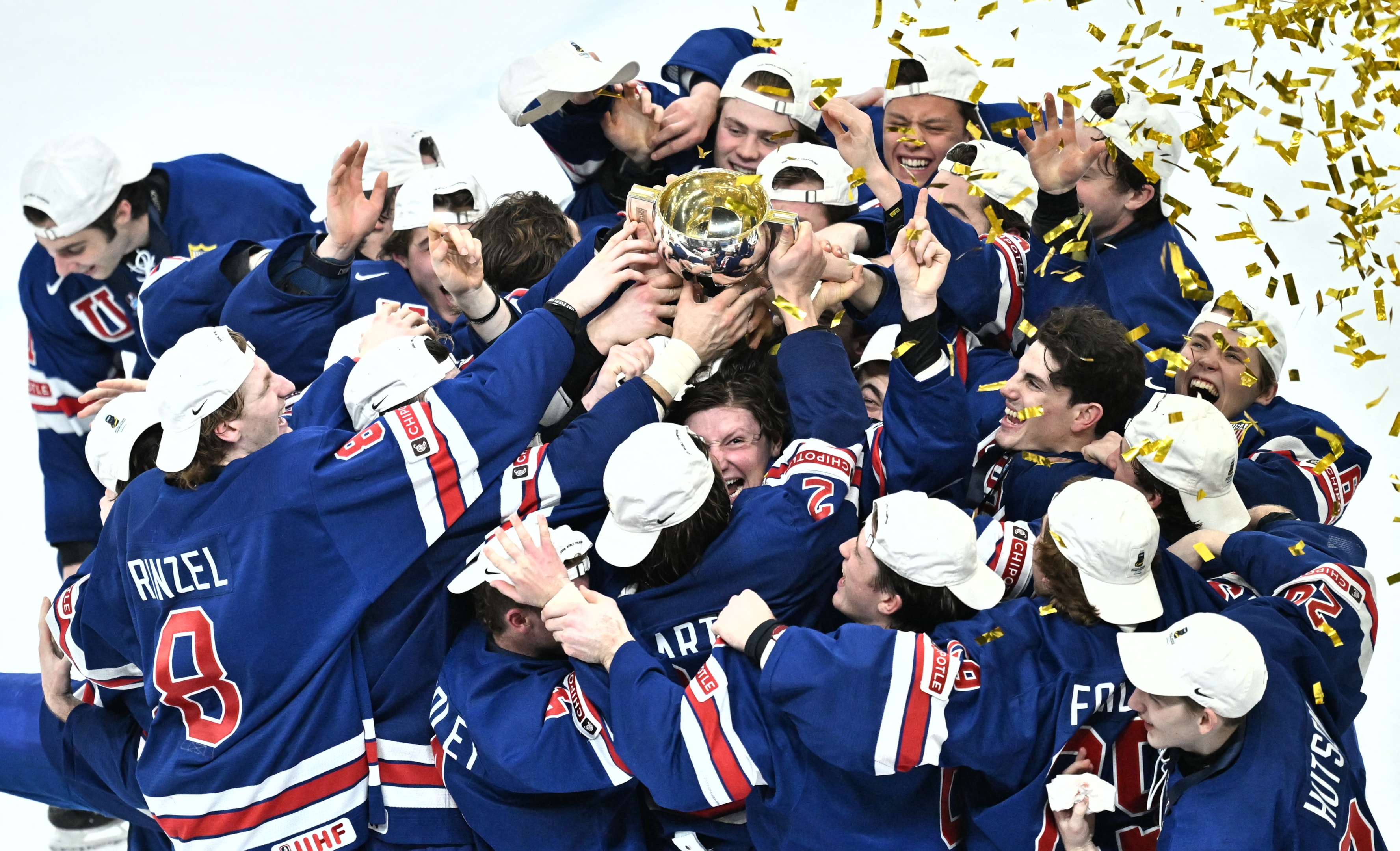 USA's players celebrate with the trophy after winning the final ice hockey match between USA and Sweden of the IIHF World Junior Championship in Gothenburg, Sweden on January 5, 2024. 