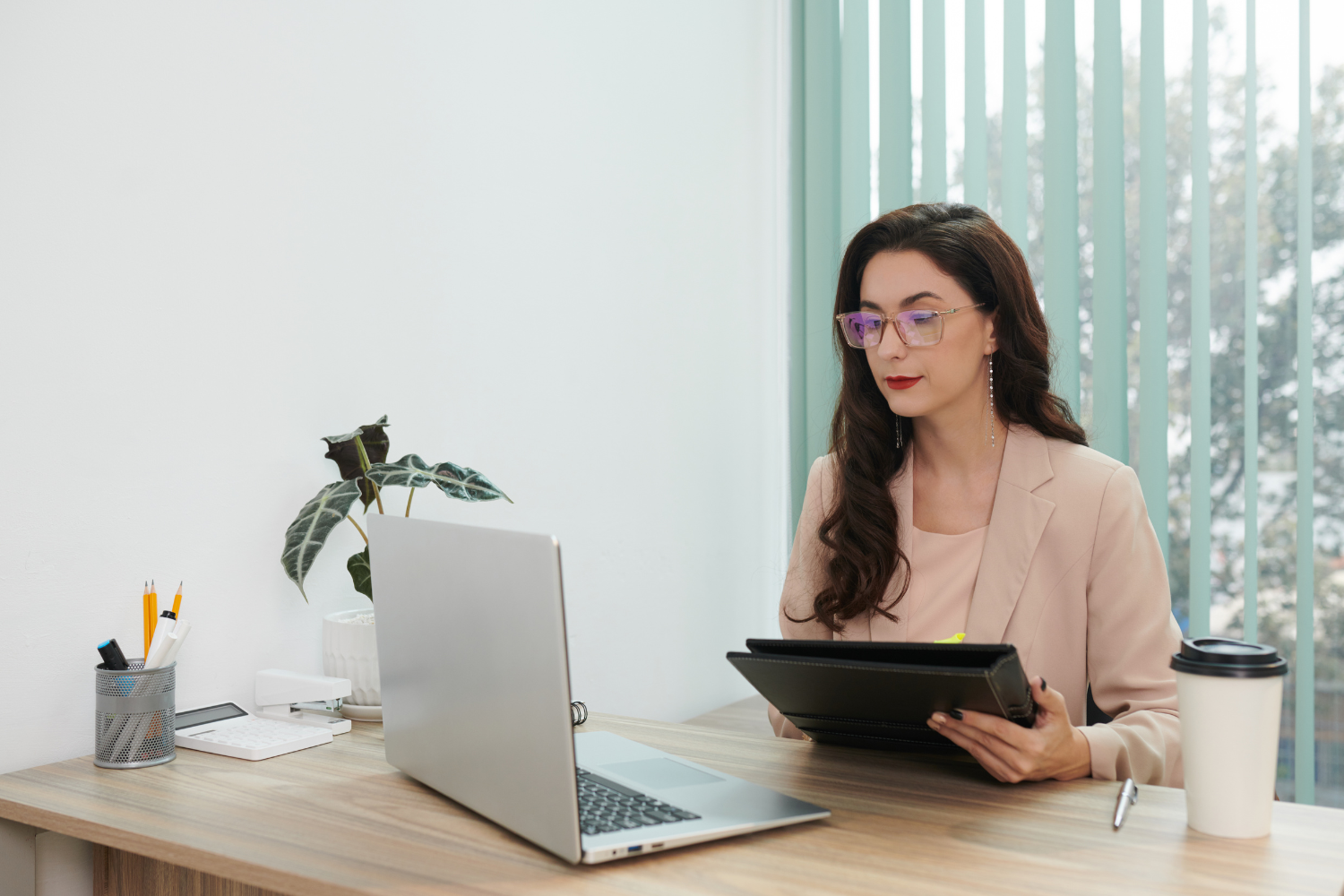 An HR manager reviewing documents in her desk.