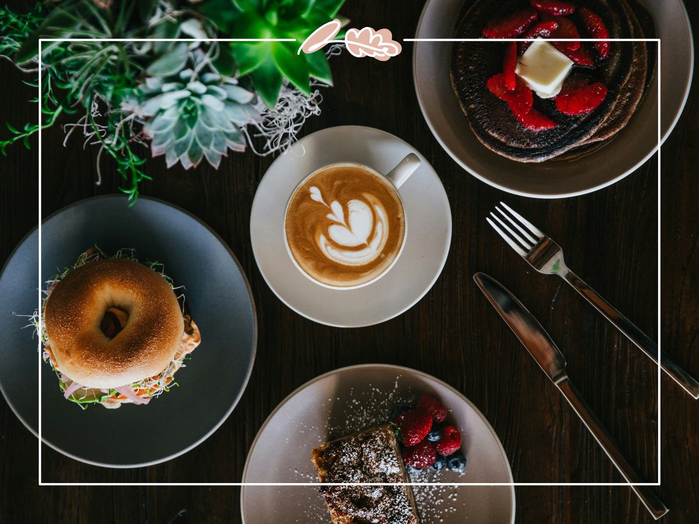 Breakfast spread with a latte, a bagel, and pancakes topped with fresh strawberries. Fabulous Flowers and Gifts