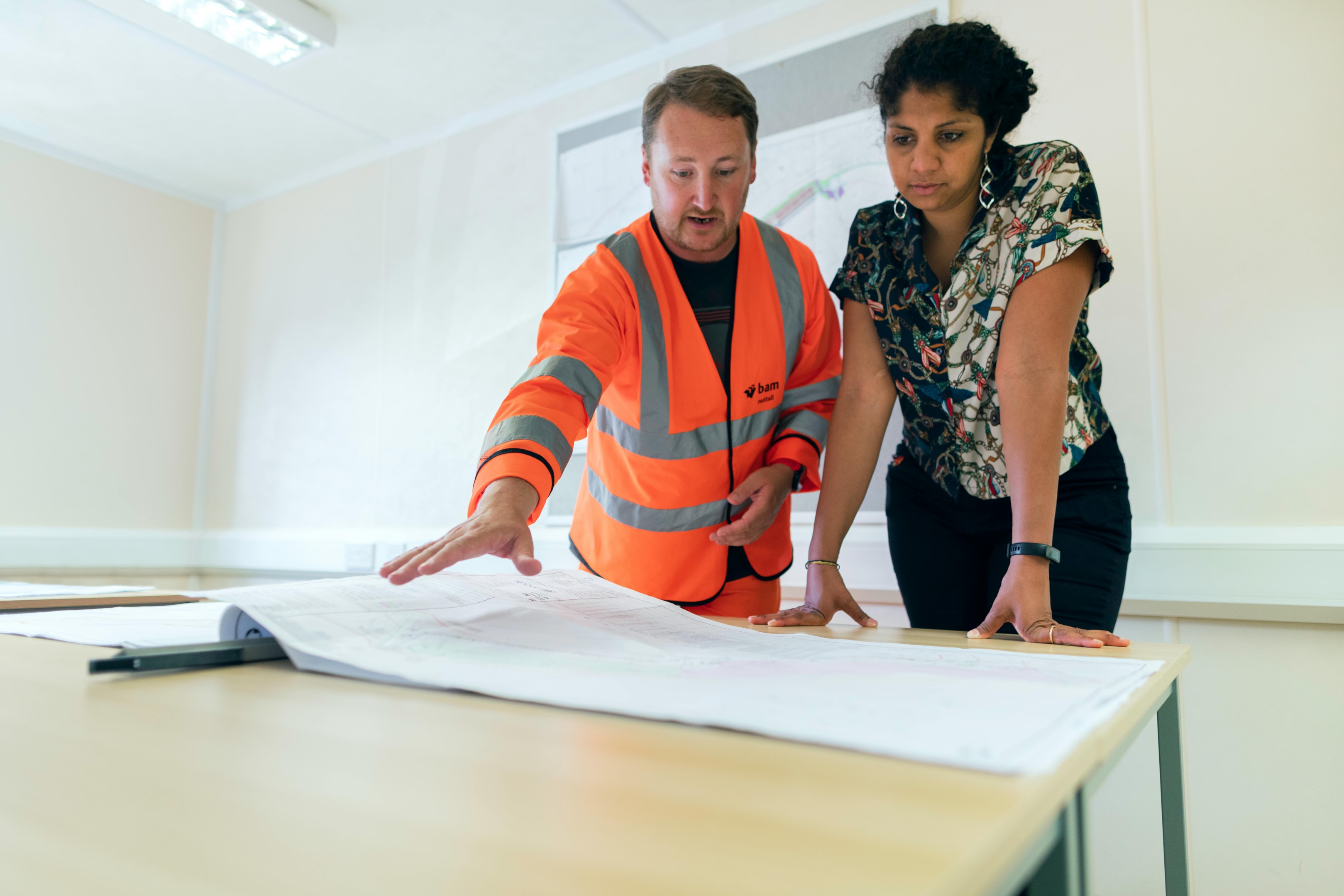 Contractor reviews plans of renovations for a fire damaged property with the owner.