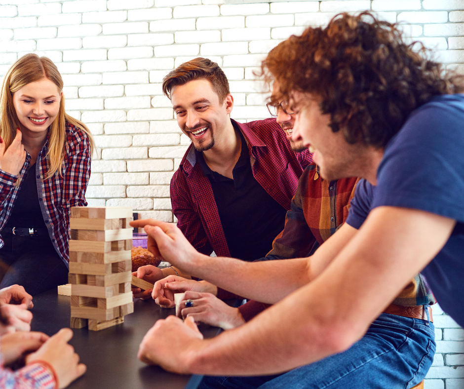 A group of friends playing board games and having fun, as an alternative to drinking at a party for what to do instead of drinking at a party section.