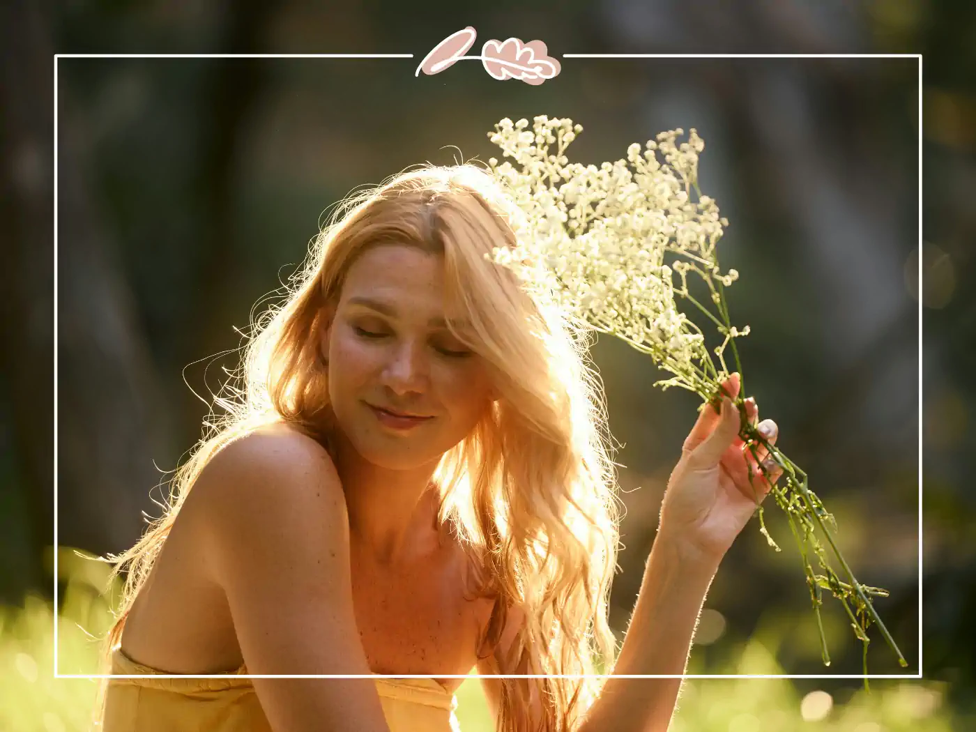 A woman in a field with a gentle smile, holding a bouquet of delicate white flowers, symbolising new beginnings and beauty.