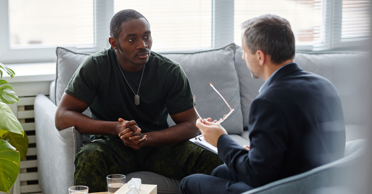 A person sitting in front of a therapist, seeking burned out professional help