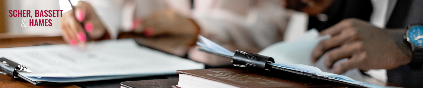 A female lawyer in a professional setting reviewing documents related to personal injury lawyer fees and percentages in California.