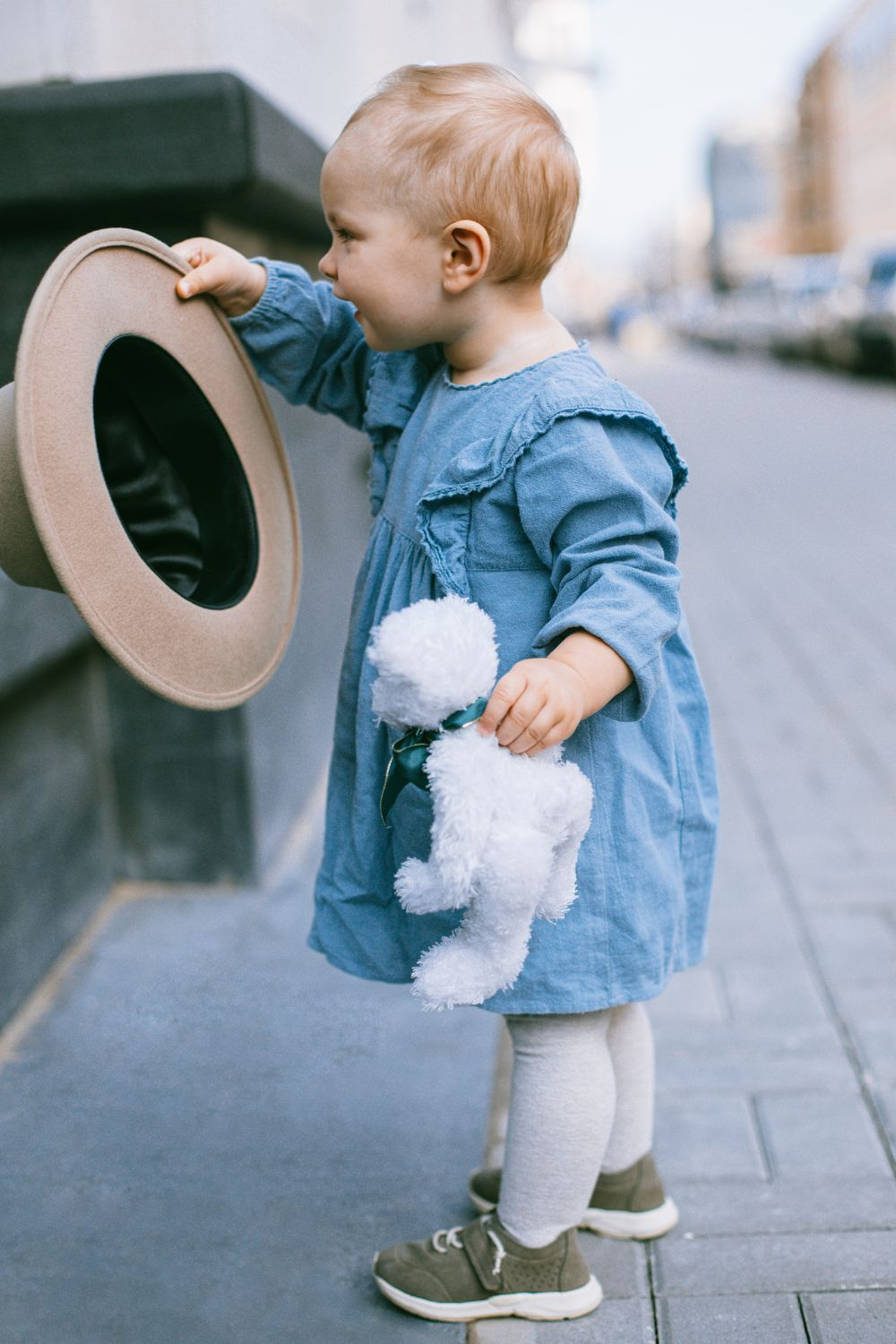 Toddler playing with hat