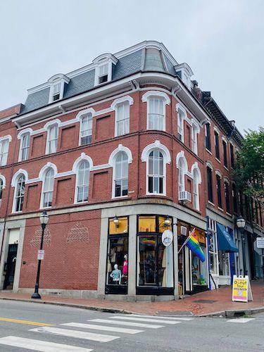 Pride flag on a historic building in the Old Port area of Portland, ME