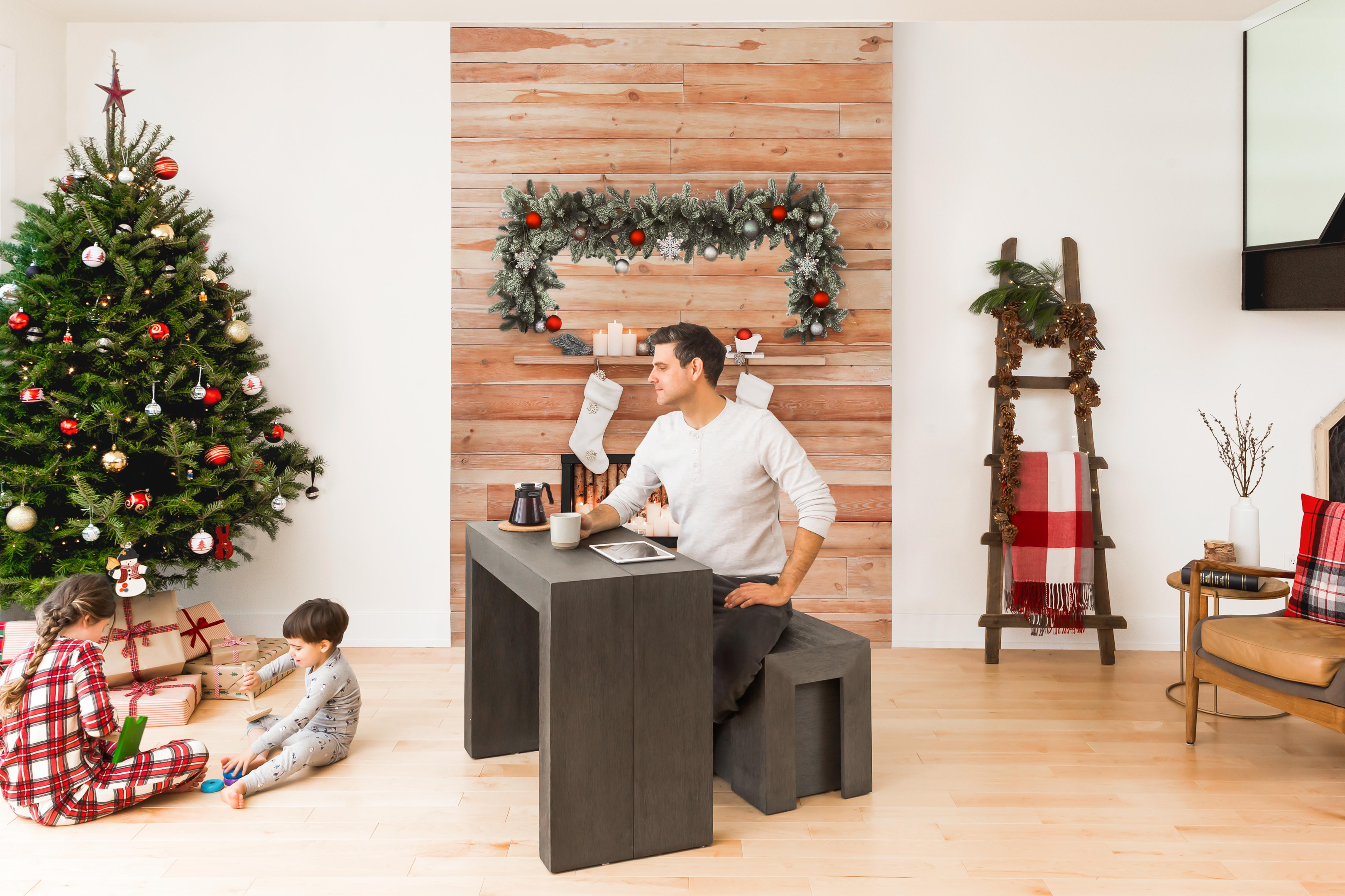 A man with his children sitting at a desk at Christmas