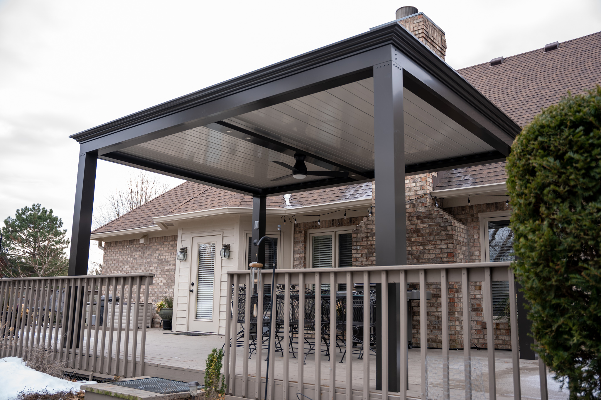 A bronze, powder coated louvered roof system can keep you safe in inclement weather.