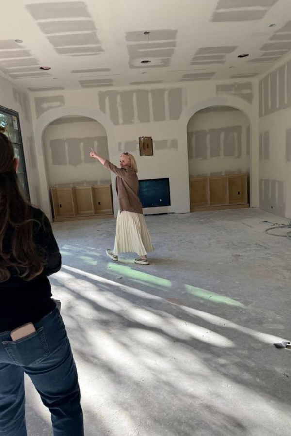 Laura Umansky walks a job site with drywall and built-ins