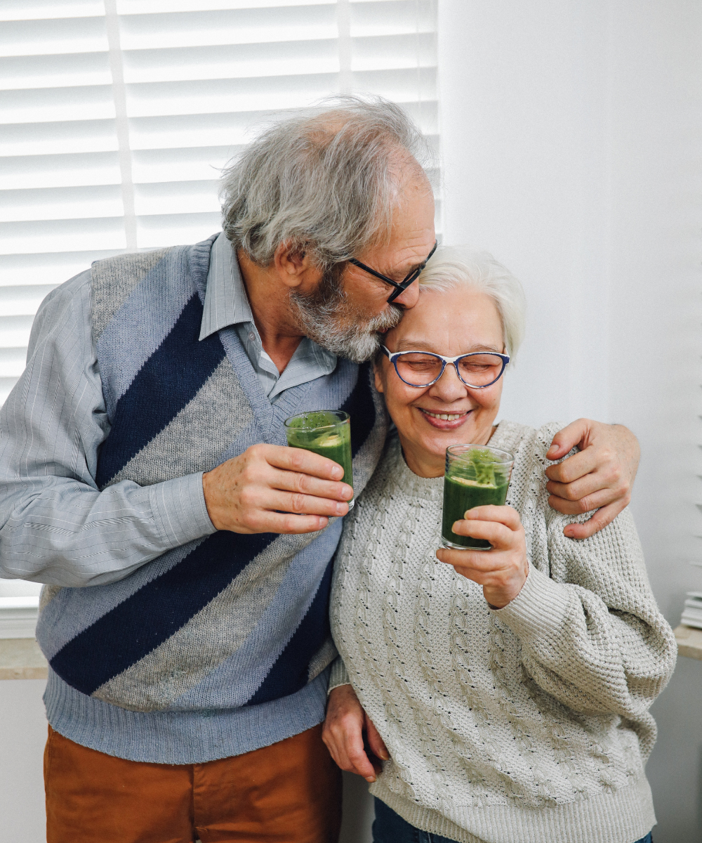 A couple drinking a glass of celery juice