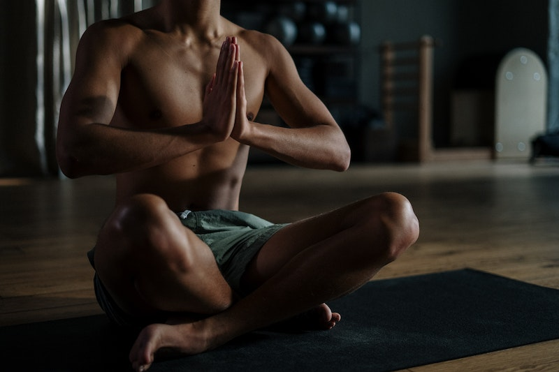 Death practice: Man meditating on a yoga mat