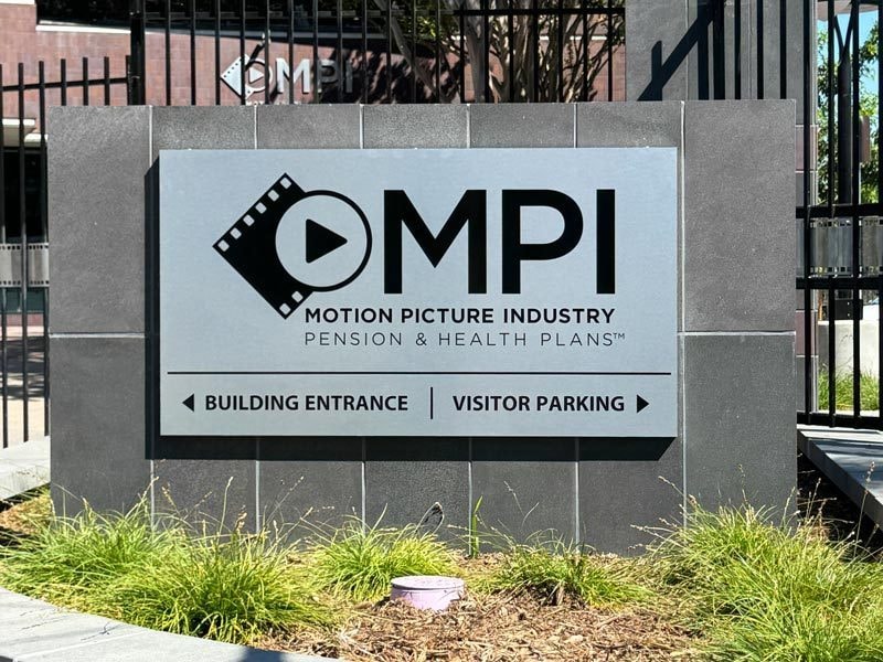 MPI, Motion Picture Industry monument sign with logo and wayfinding.