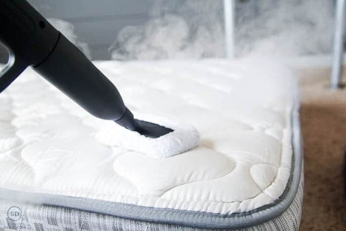 Professional steam cleaning a mattress with a handheld steam cleaner by Cleanology SG, demonstrating effective deep cleaning methods to remove stains, dust mites, and allergens for a hygienic sleep environment in Singapore.