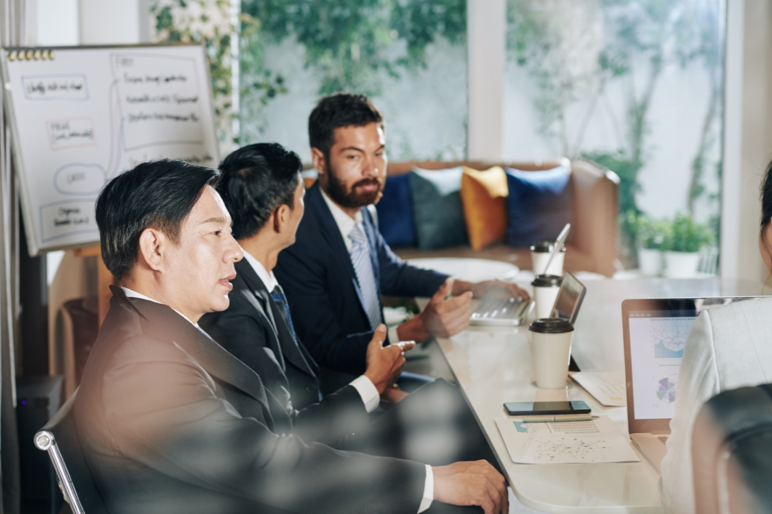Business leaders discussing strategy in an in-person meeting