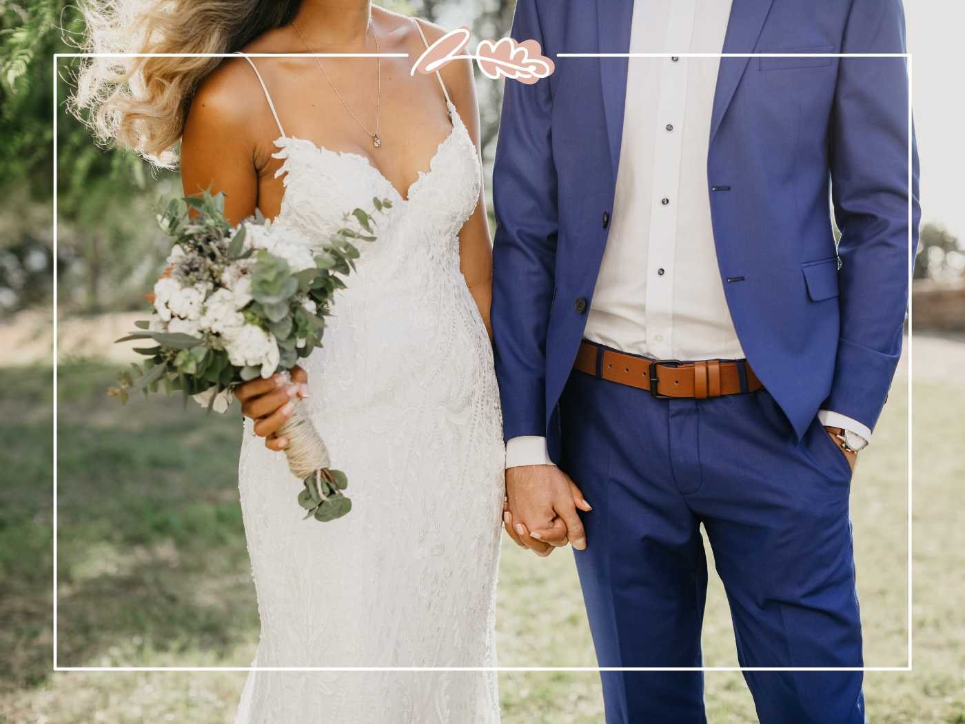 The bride and groom holding hands, the bride carrying a bouquet of white flowers, set against a natural backdrop. Fabulous Flowers and Gifts.