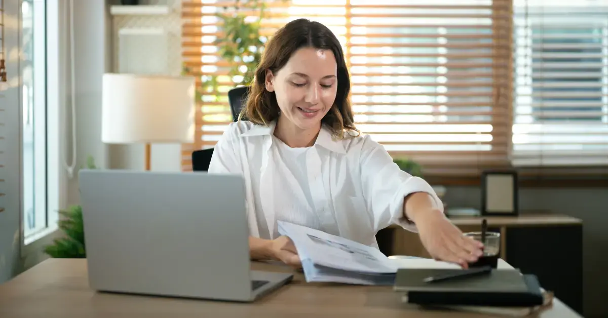 Woman reviewing IRS documents using Form SS-4 instructions to apply for an EIN.