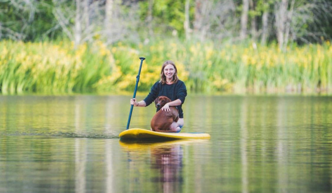 woman and dog on a paddleboard