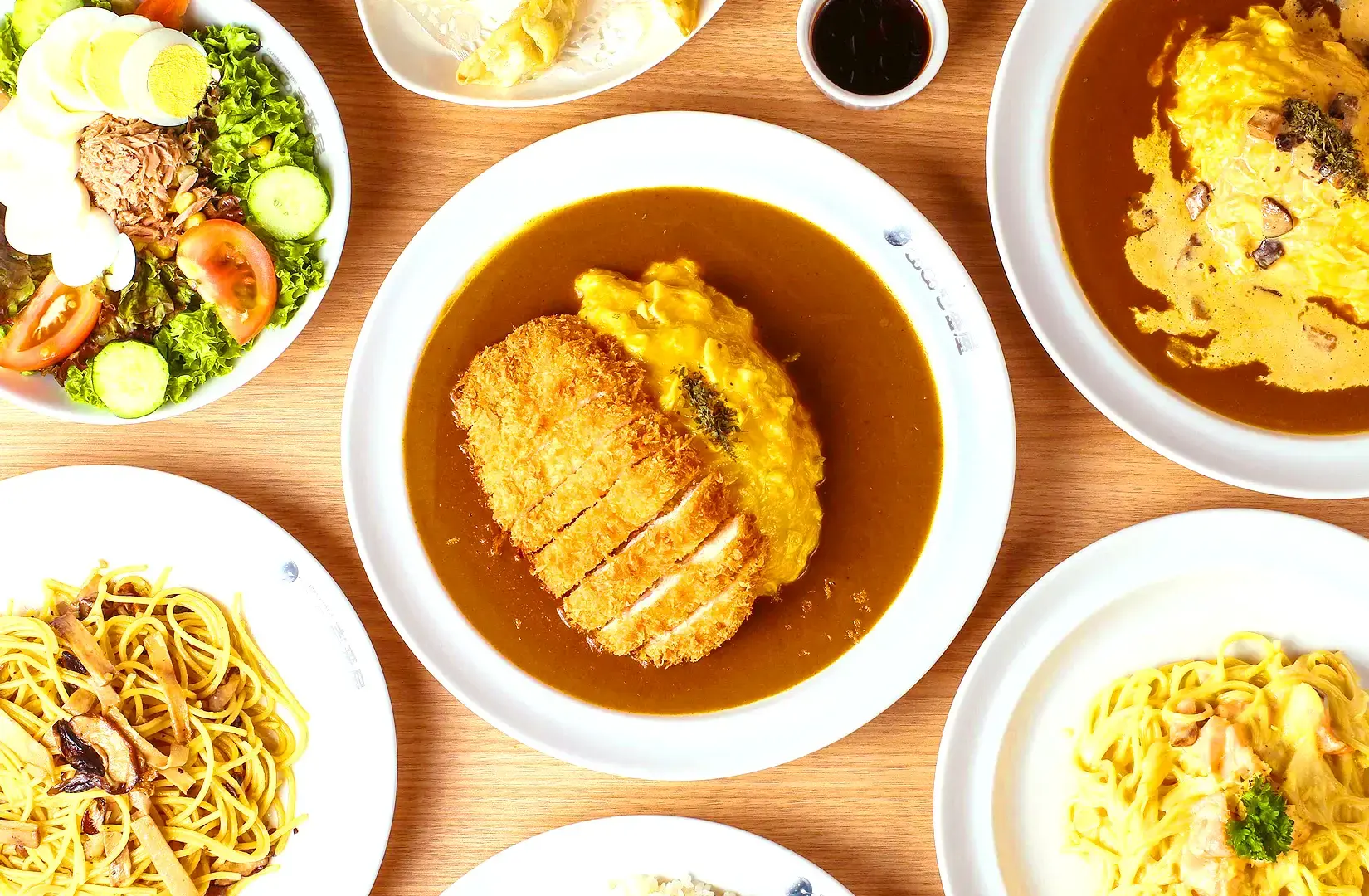CoCo Ichibanya Singapore Japanese curry spread with chicken katsu curry, omelette curry and pasta dishes