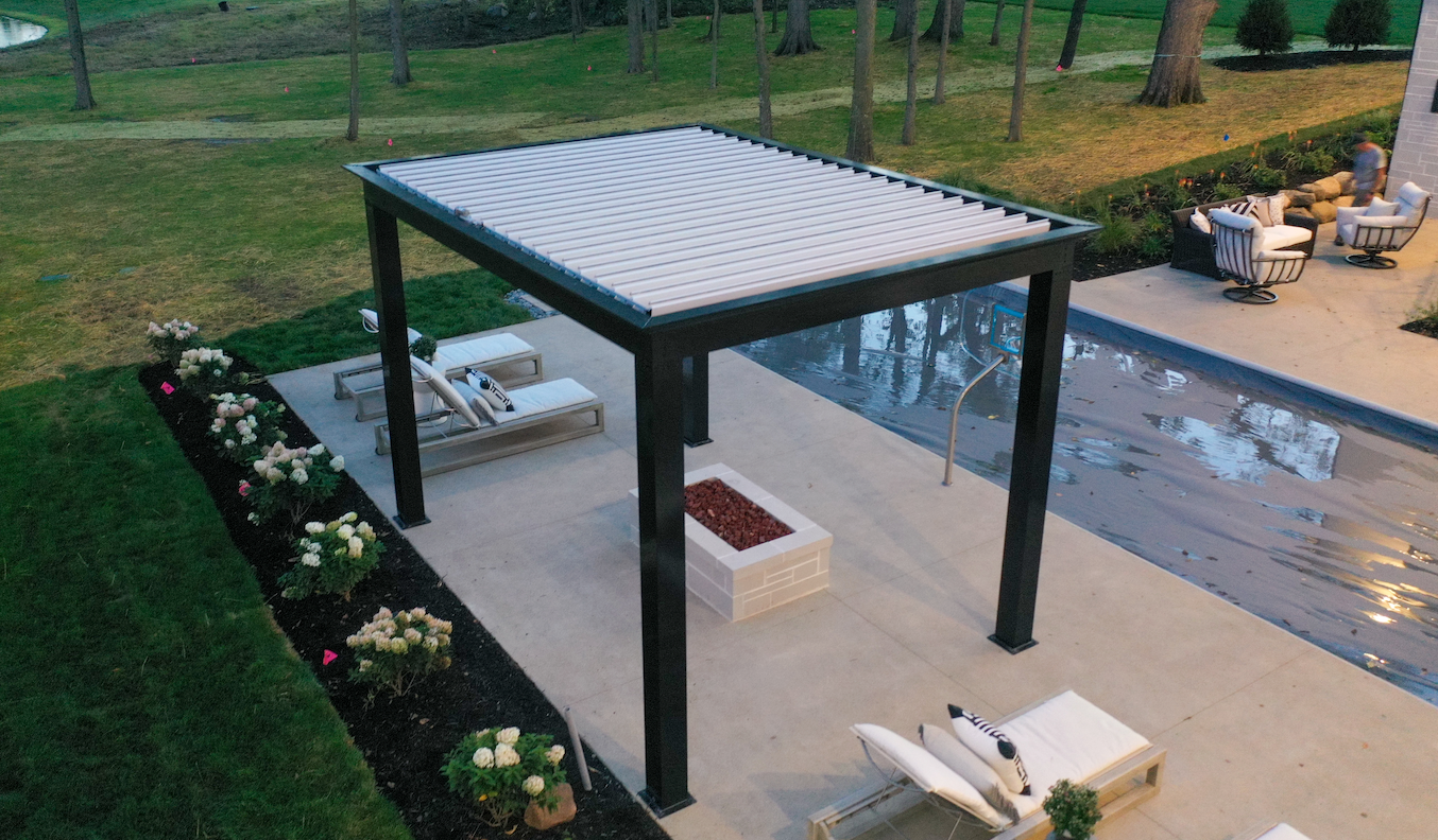 Black and white modern freestanding pergola in backyard patio area with a pool