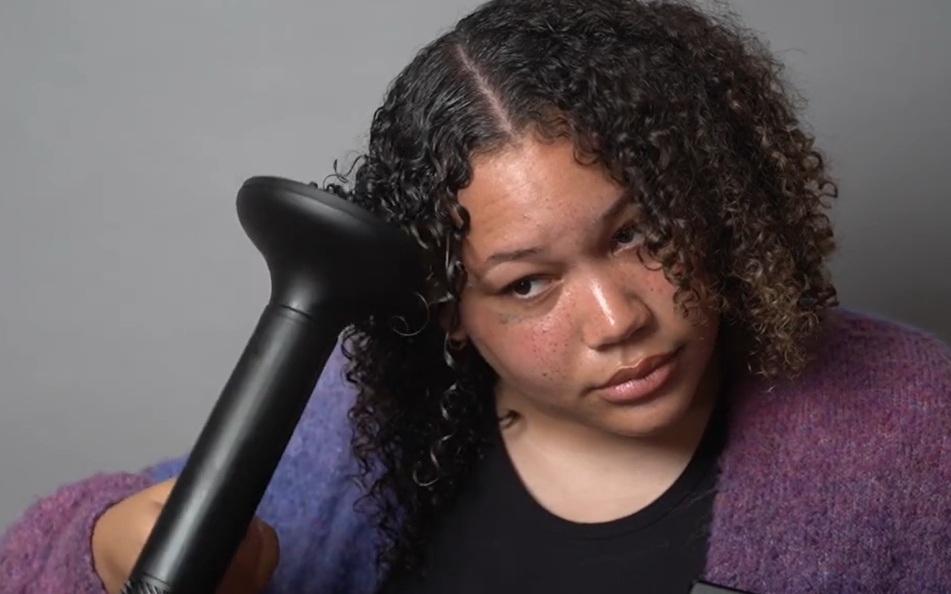 woman blow drying her hair
