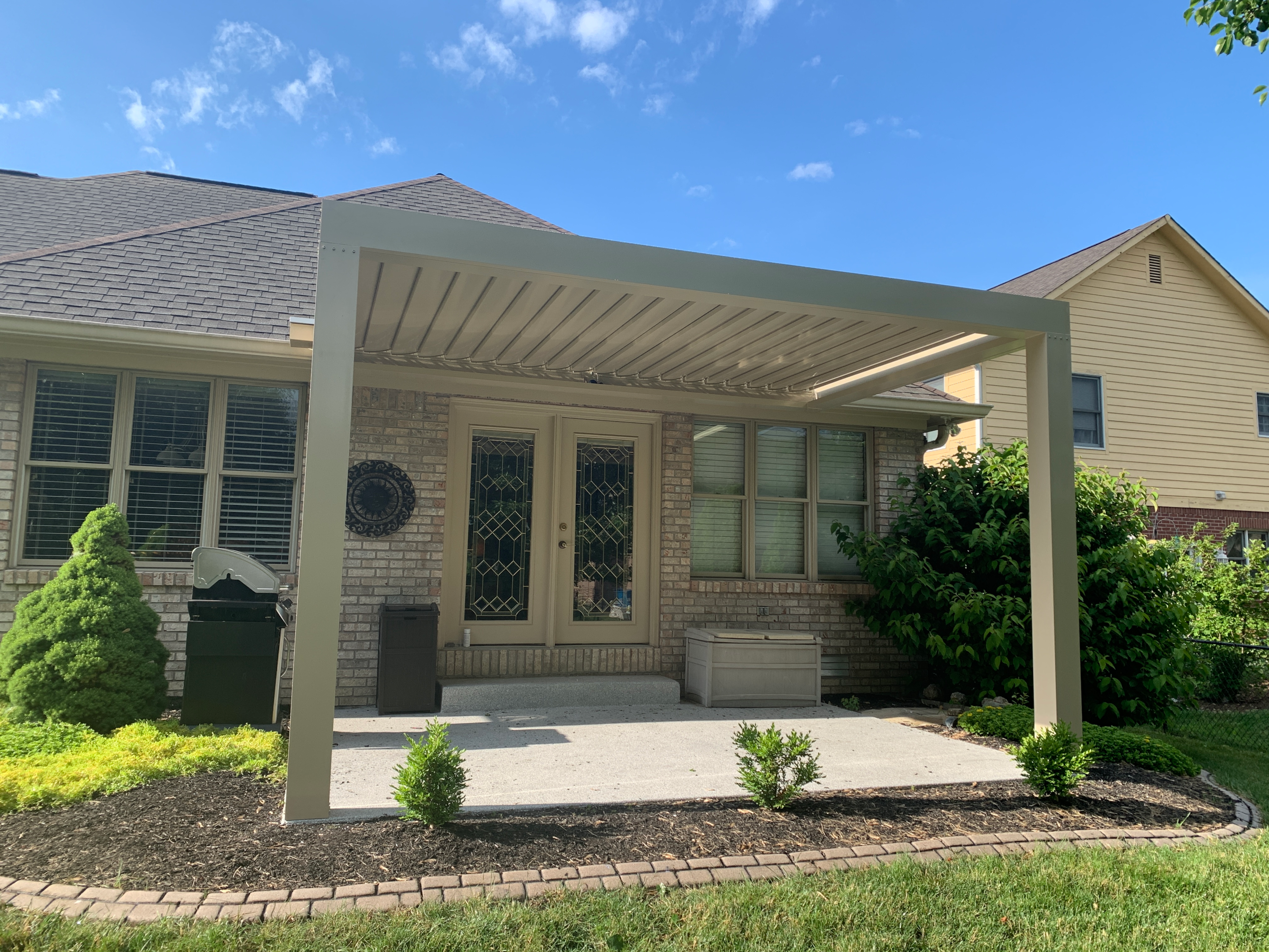 White Pergola With Stone Features