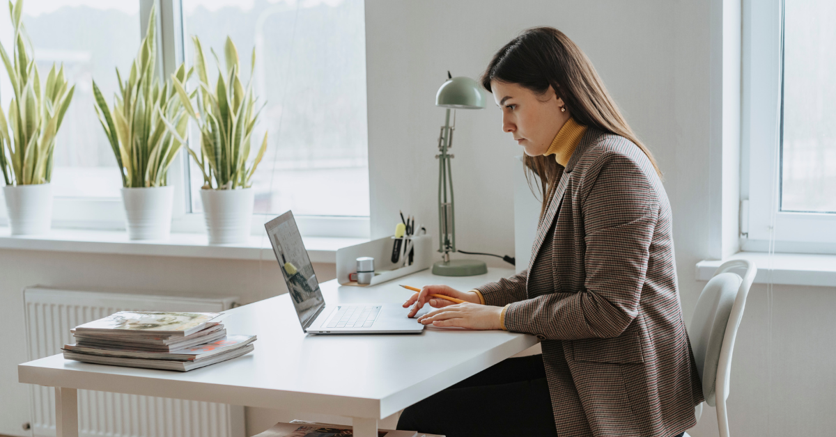 Tax preparer reviewing the Google AdSense tax form on a laptop, preparing taxes for an OnlyFans creator.