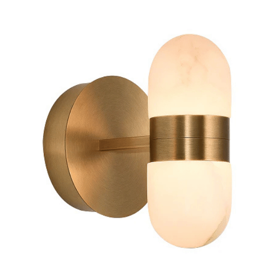 Brushed gold wall sconce with a capsule-shaped frosted glass diffuser, emitting soft ambient light.