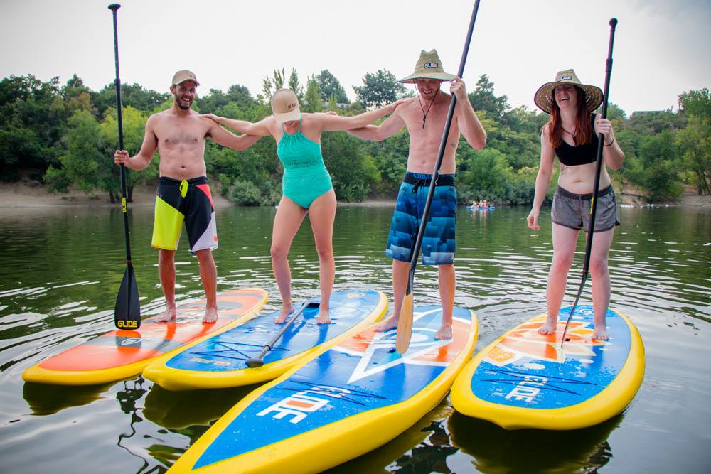 people on solid paddle boards