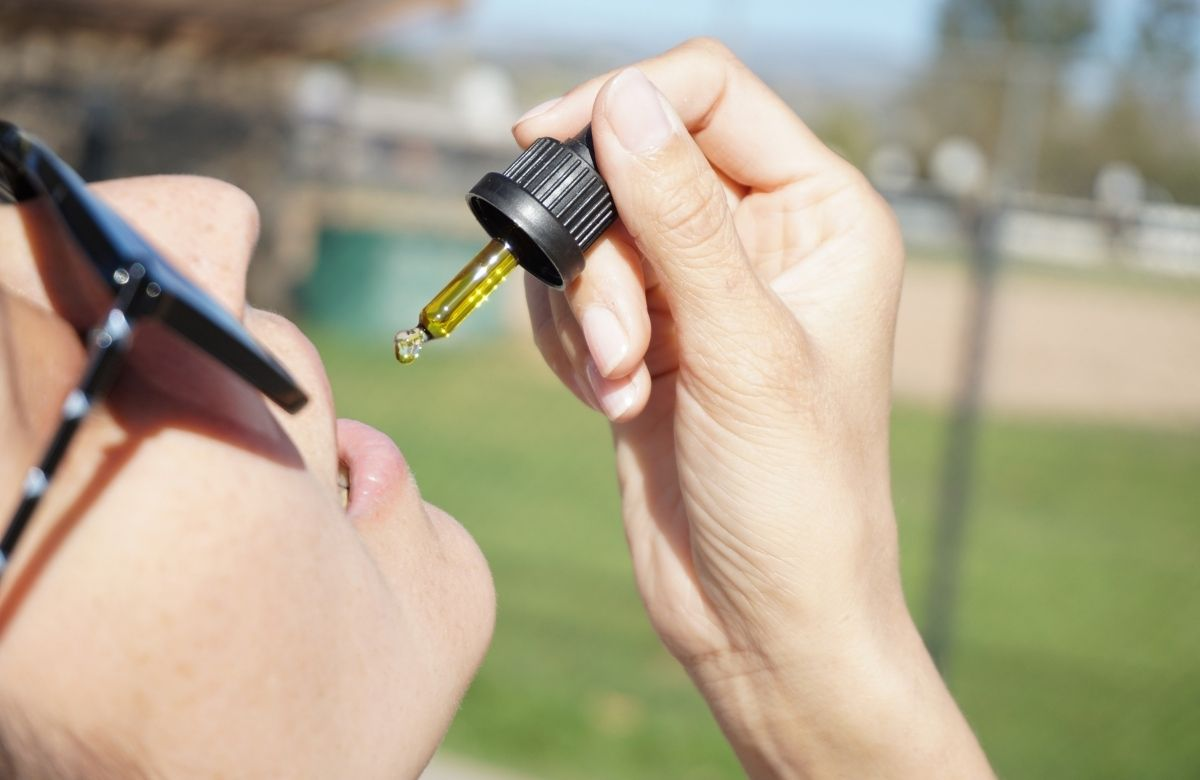 Woman Consuming CBD Oil orally