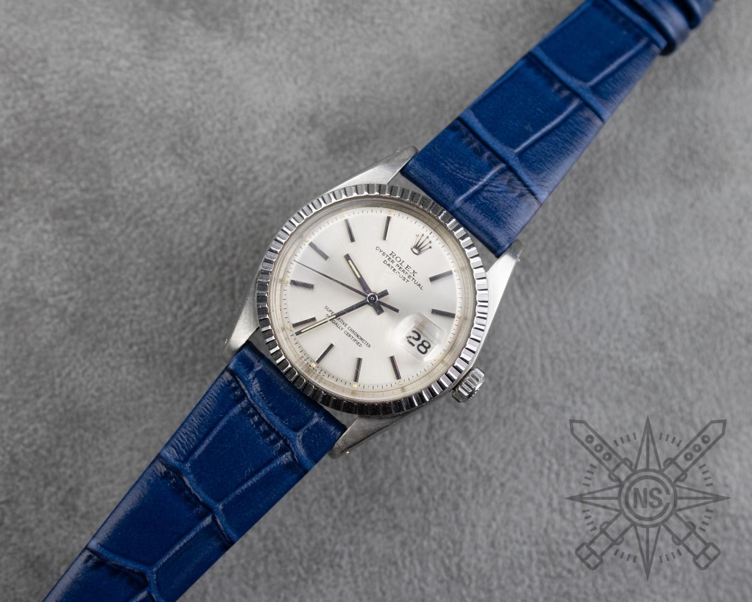 A close-up of a blue alligator watch strap showcasing its texture.