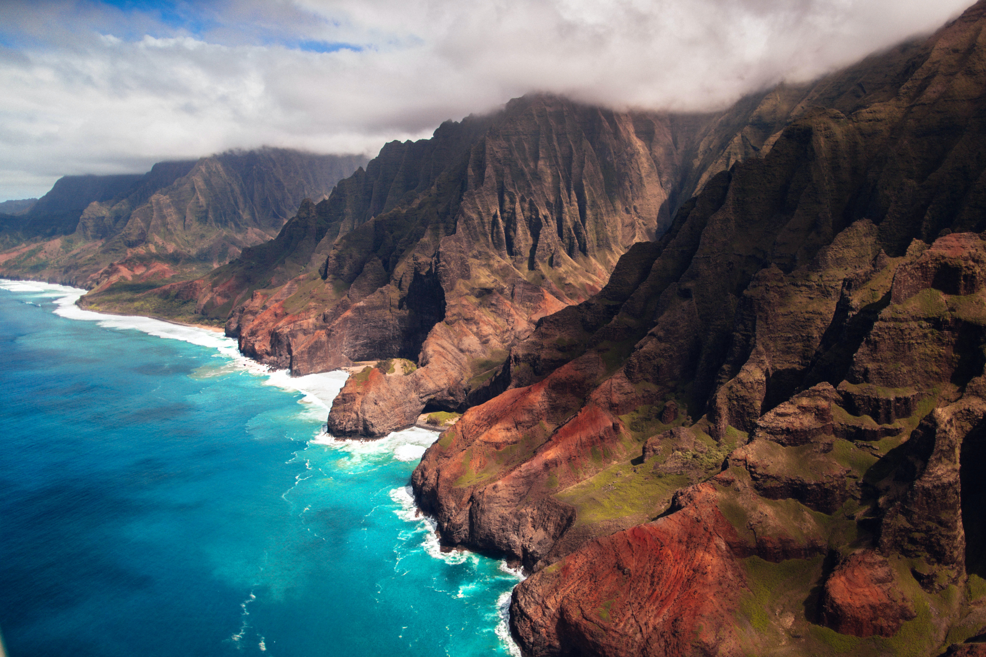 An aerial view of Na Pali Coast in Kauai. A helicopter ride for this view is one of the amazing things to do in Kauai.